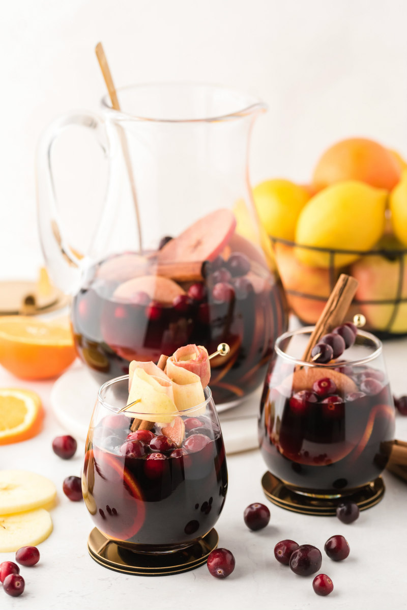 pitcher with two glasses of apple cranberry sangria