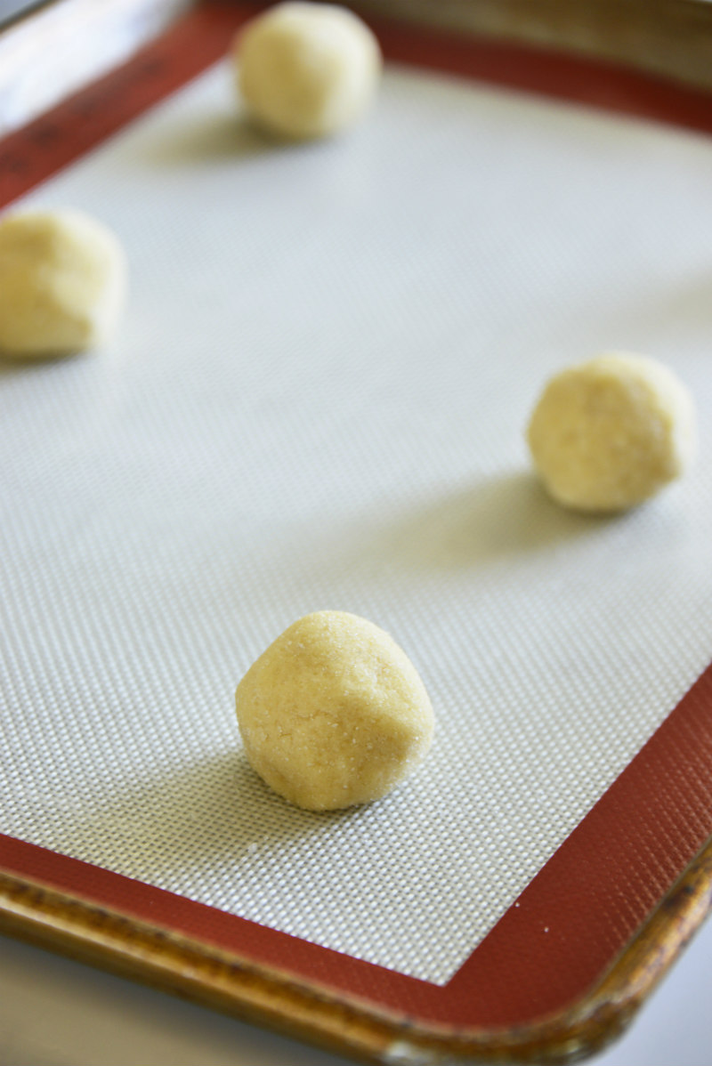 cookie dough balls on baking sheet