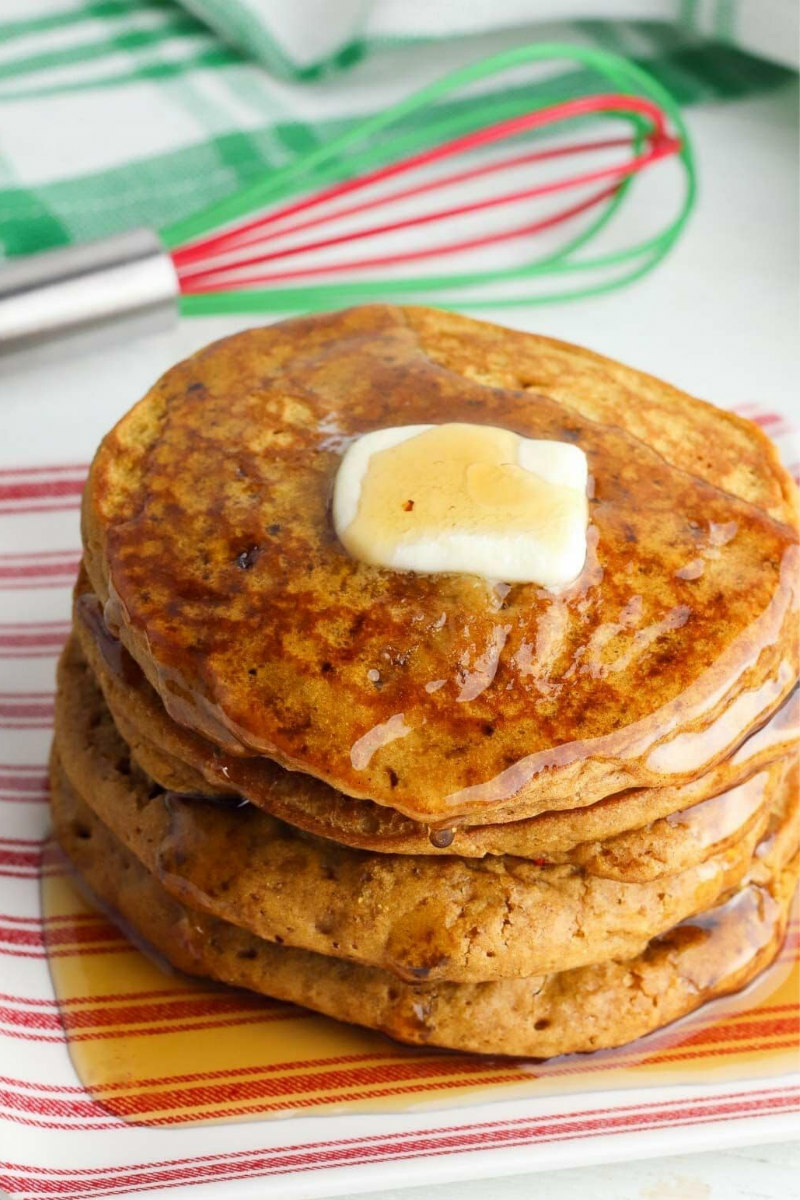 stack of gingerbread pancakes with butter and syrup