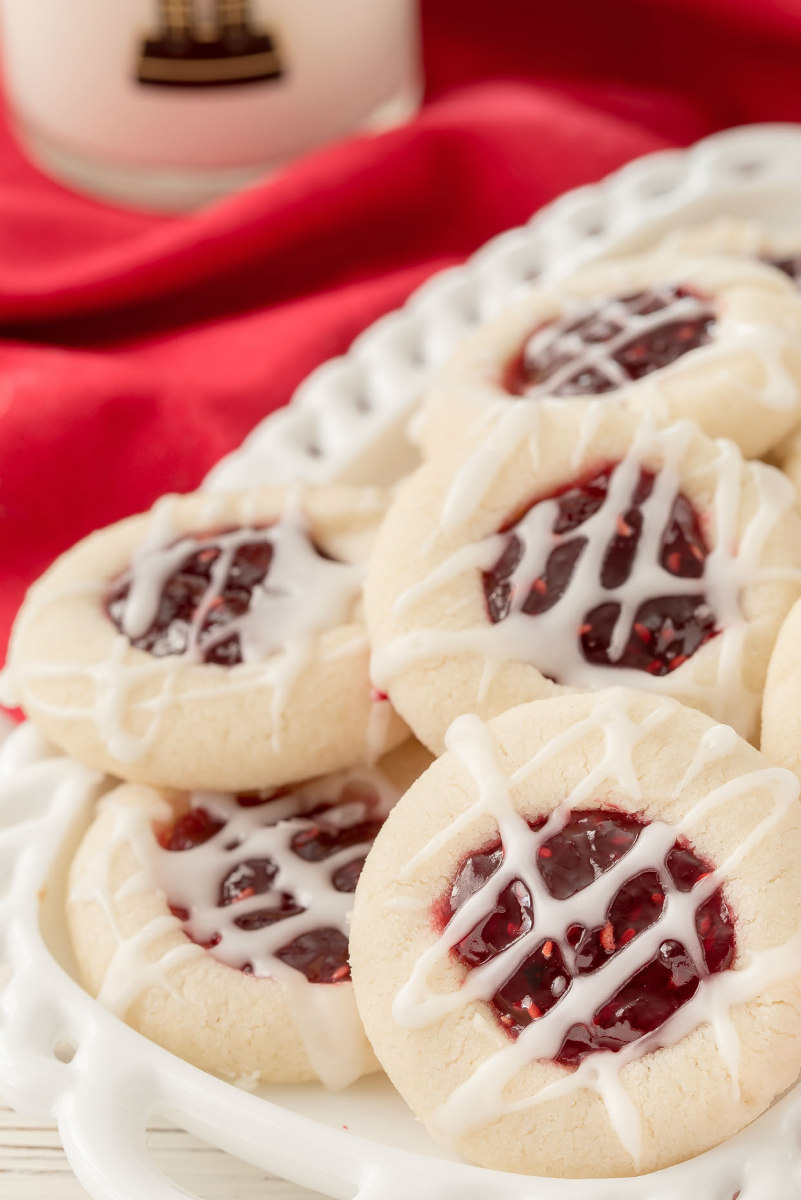 raspberry thumbprint cookies on white platter