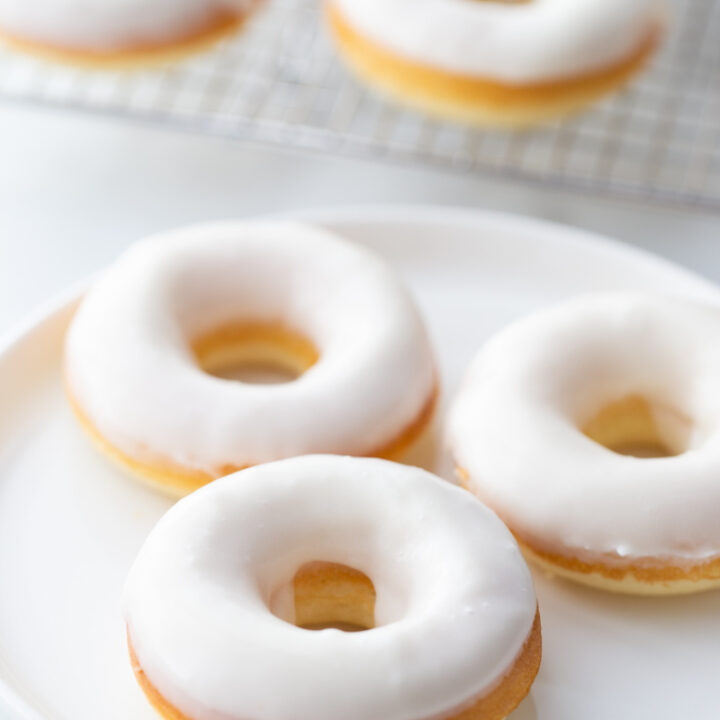 white glazed doughnuts on white plate