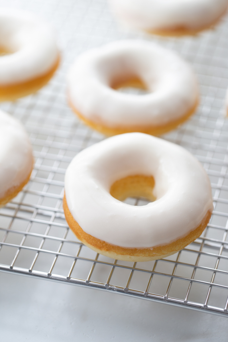 baked glazed doughnuts on a cooling rack