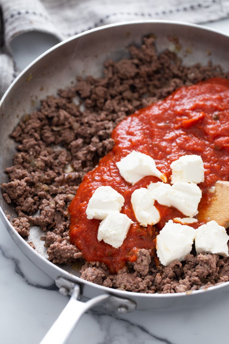 ground beef, tomato sauce and cheese in skillet