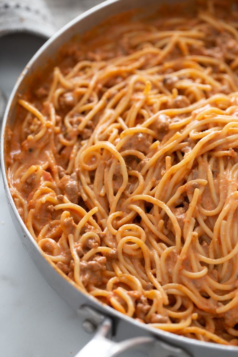 spaghetti with sauce in skillet