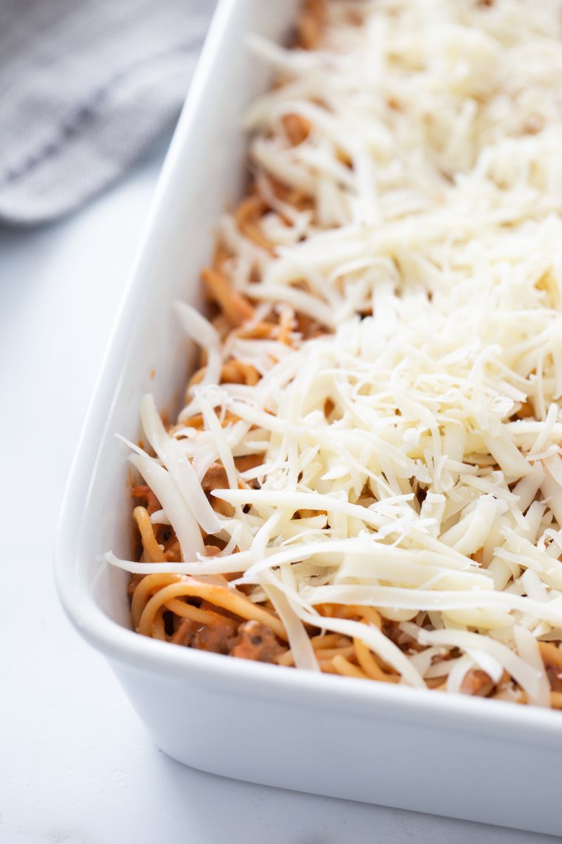 spaghetti casserole in white dish ready for oven
