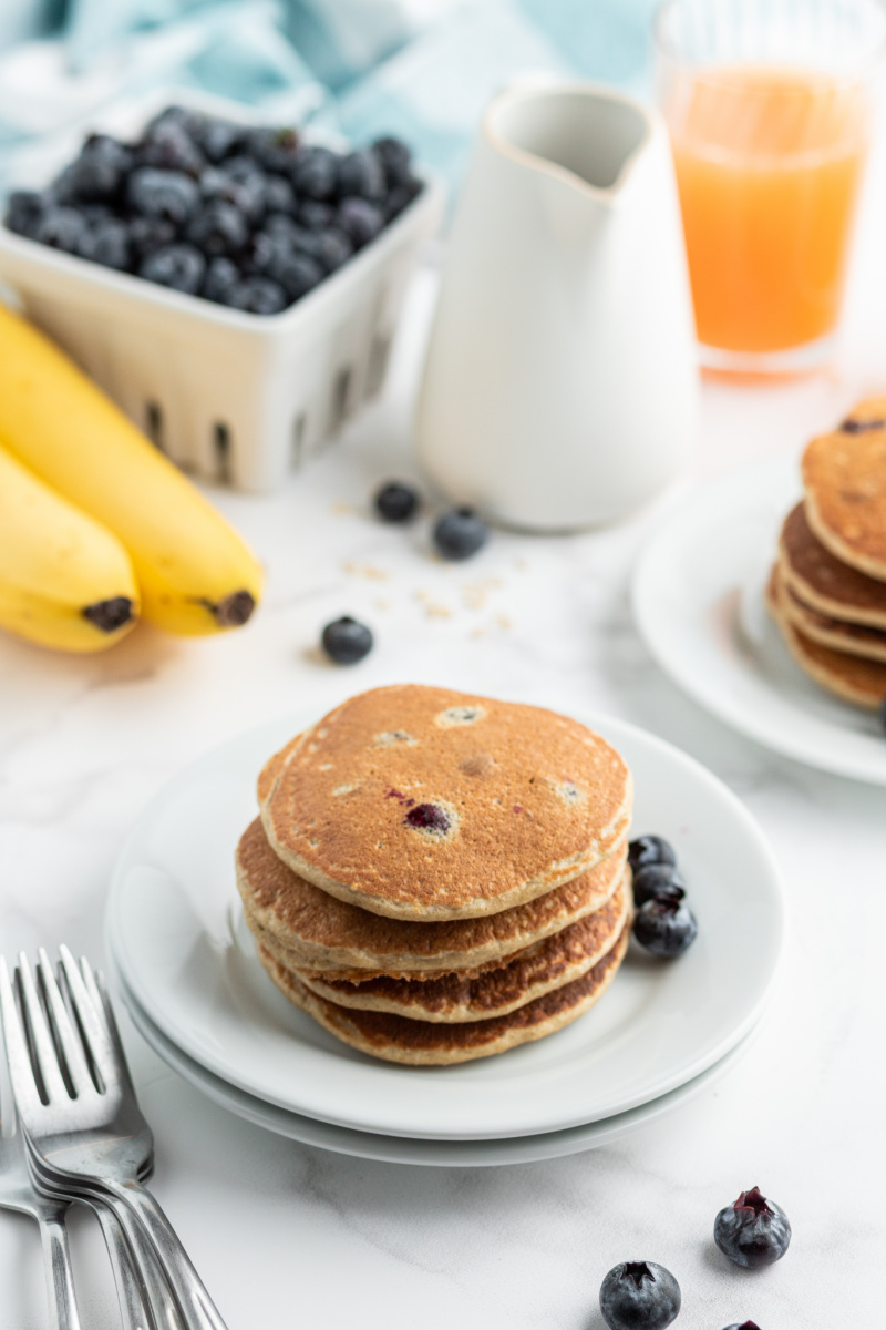 stack of blueberry pancakes on white plate