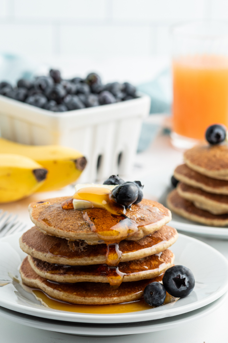 stack of banana blueberry blender pancakes with butter and syrup