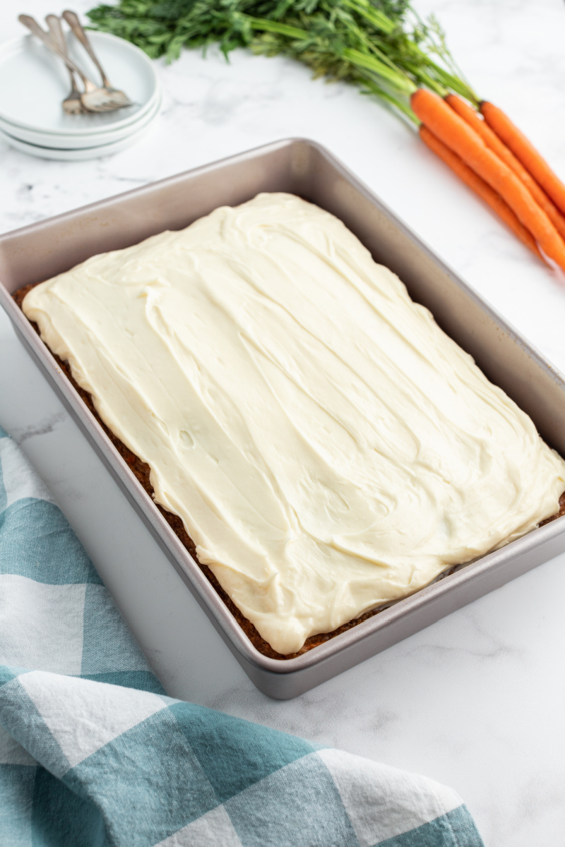 carrot cake in a pan with cream cheese frosting