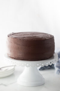 chocolate cake on a white cake stand