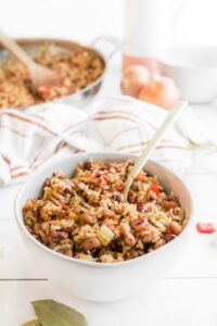 hoppin john in a white bowl with a spoon