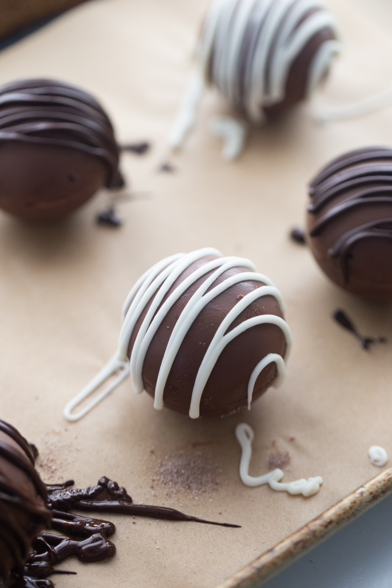 drizzling chocolate onto hot chocolate bombs