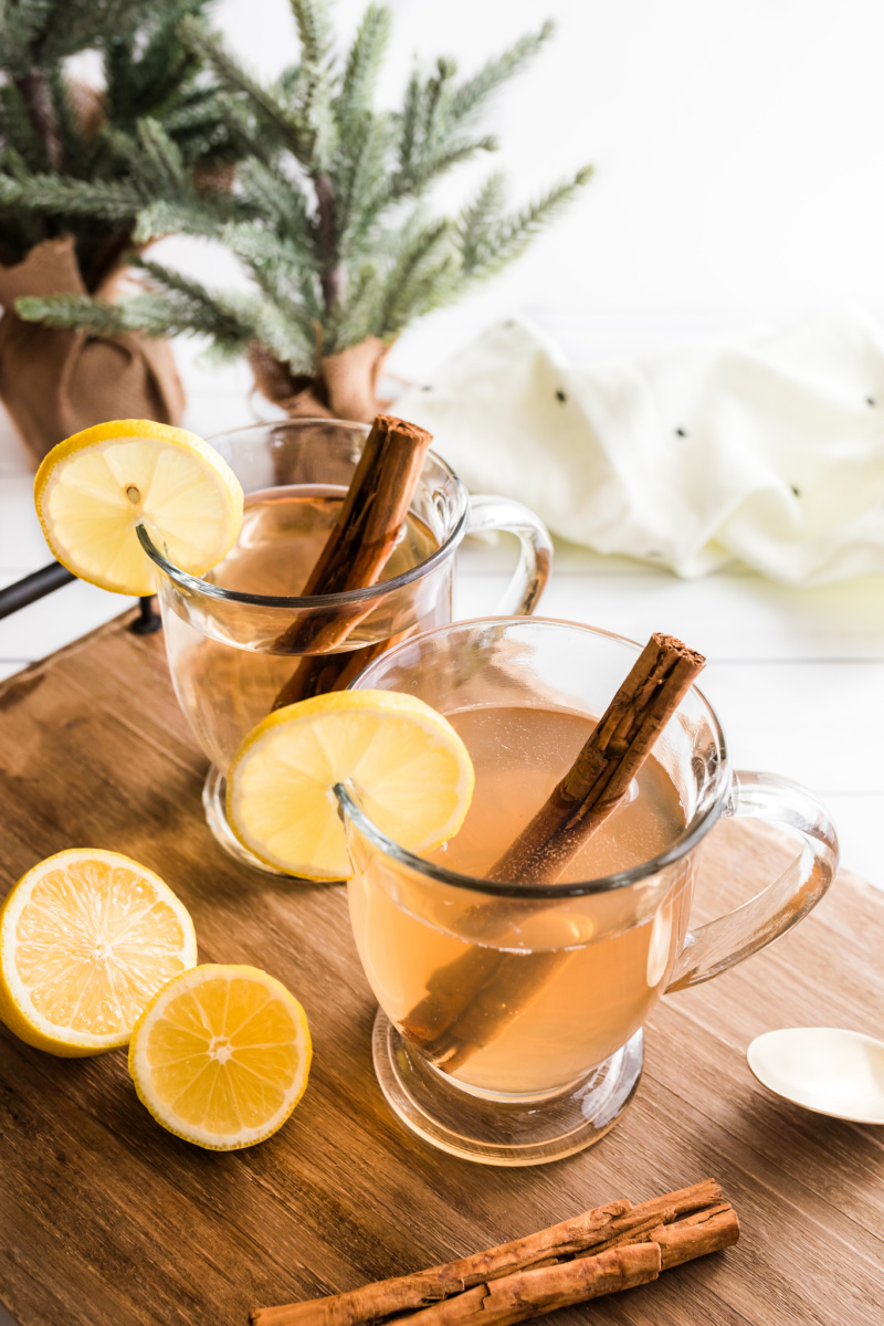 hot toddy in glass mugs with lemon and cinnamon stick