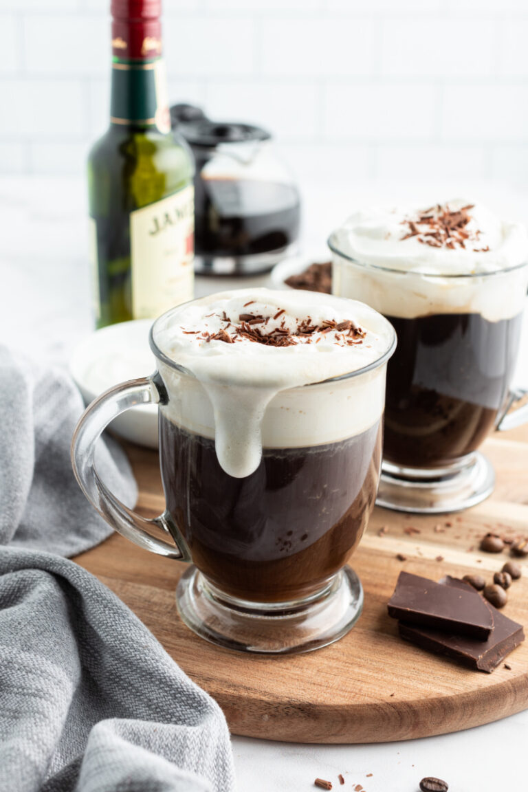 irish coffee in glass mug with foam drip down side