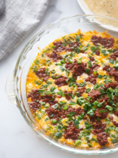 queso fundido in a glass baking dish