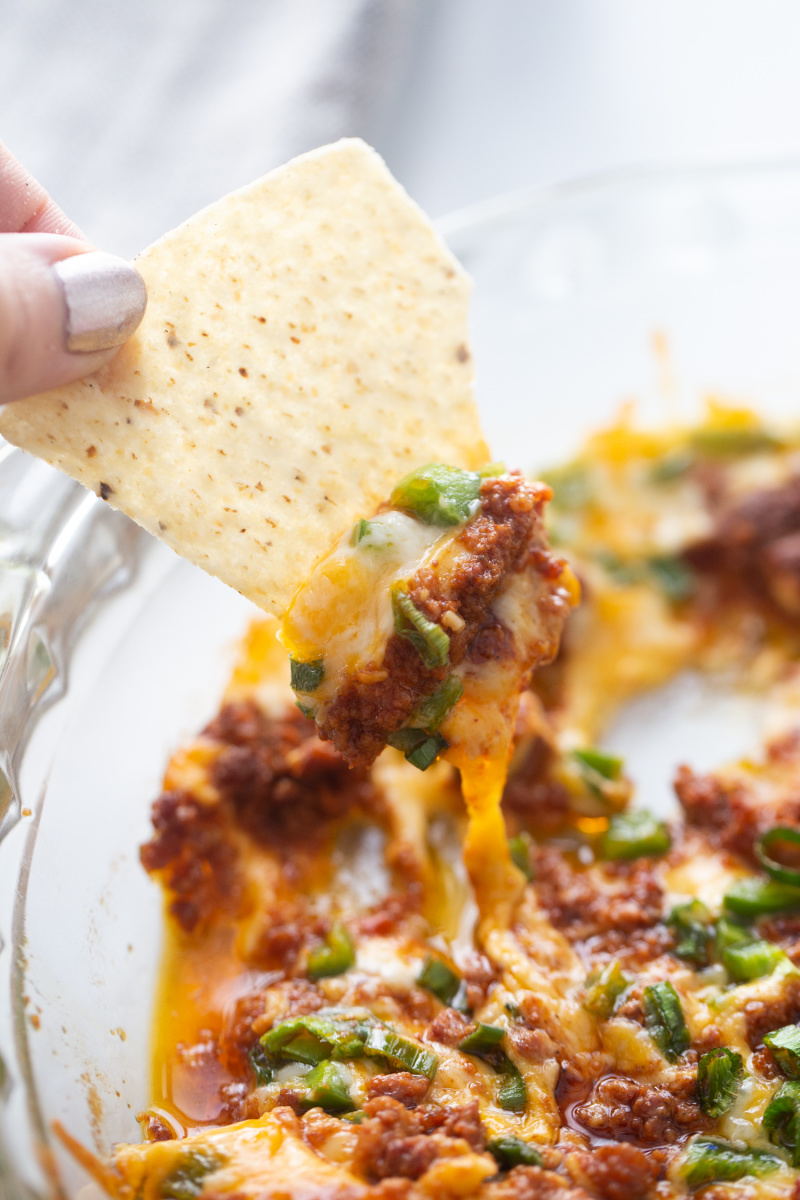 dipping chip into queso fundido