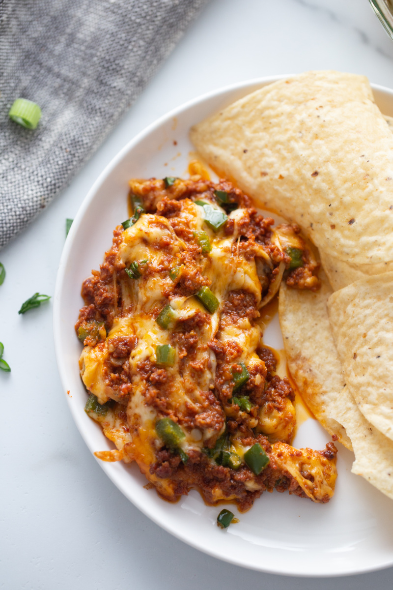 serving of queso fundido on a plate with chips