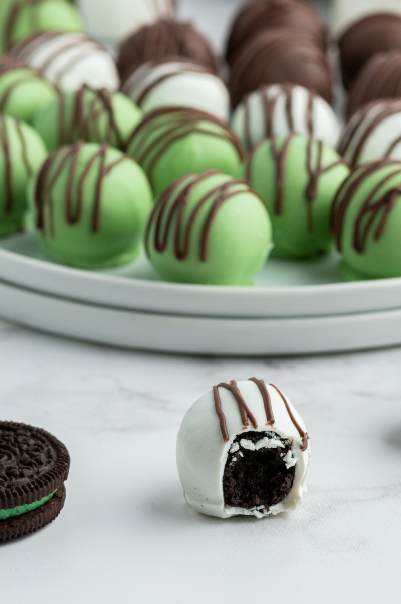 chocolate mint oreo truffle with a bite taken out of it