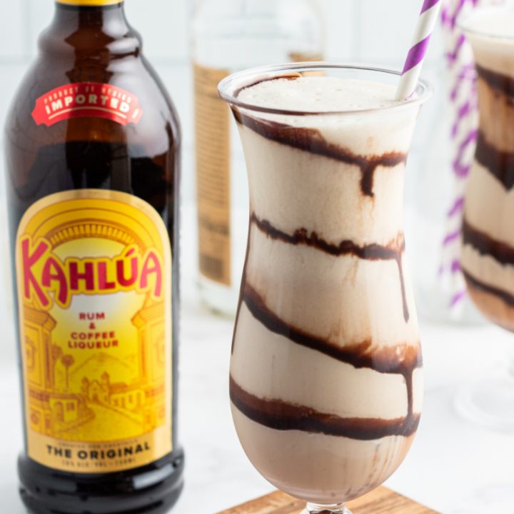 frozen mudslide in hurricane glass with a kahlua bottle