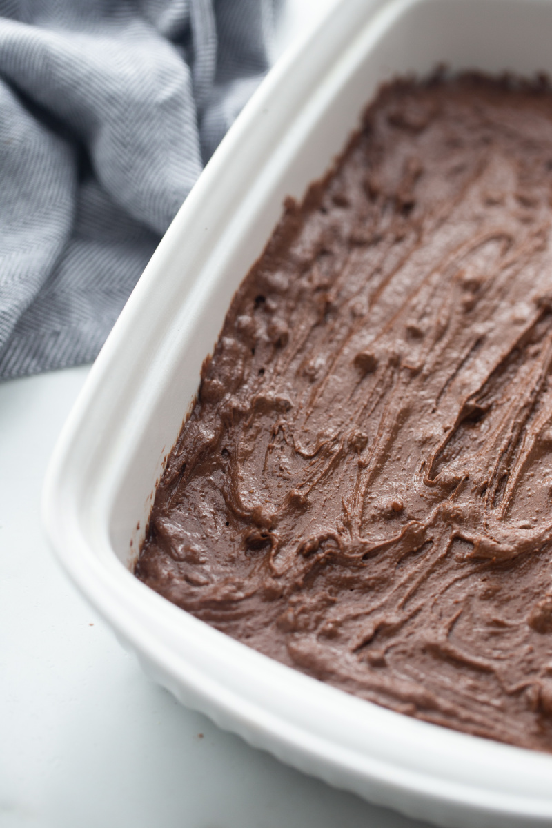 brownie batter in a white baking dish