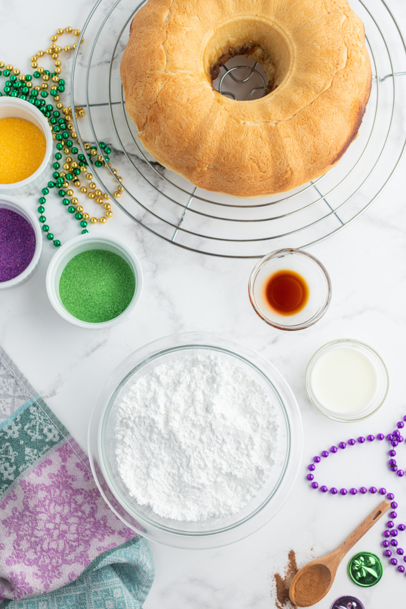 frosting and sugars displayed alongside naked king cake