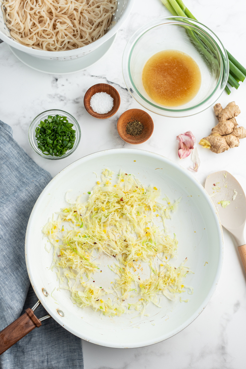 starting process of making noodles saute in pan