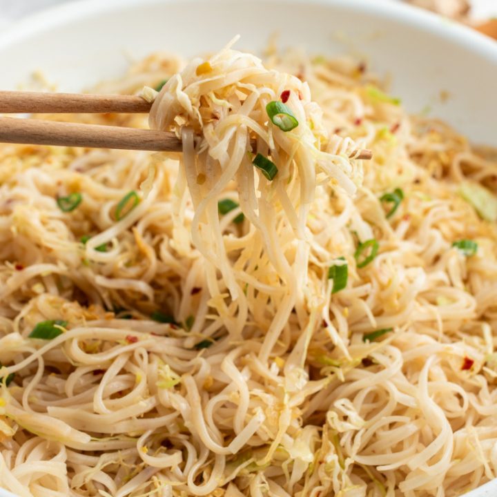 chopsticks picking up noodles from bowl