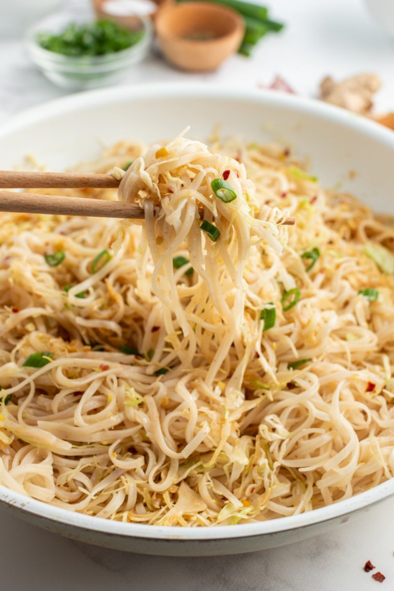 chopsticks picking up noodles from bowl