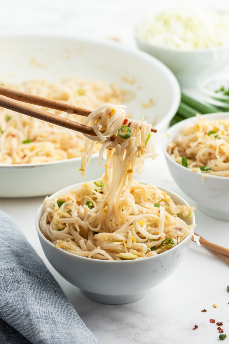 chopsticks picking up noodles out of bowl