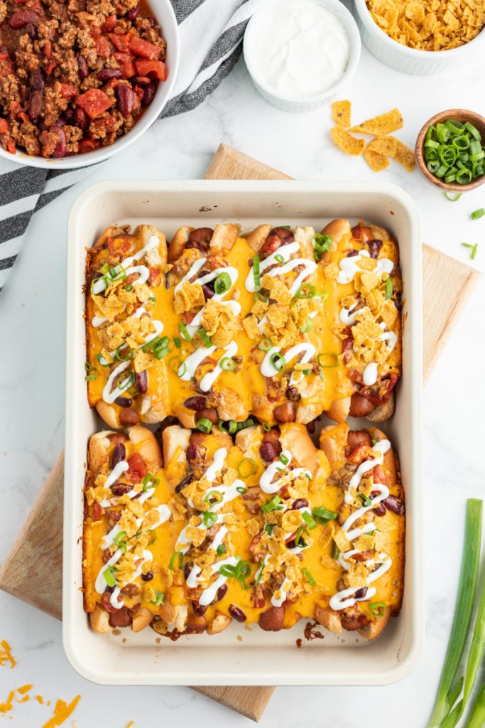baked chili dogs in white casserole dish