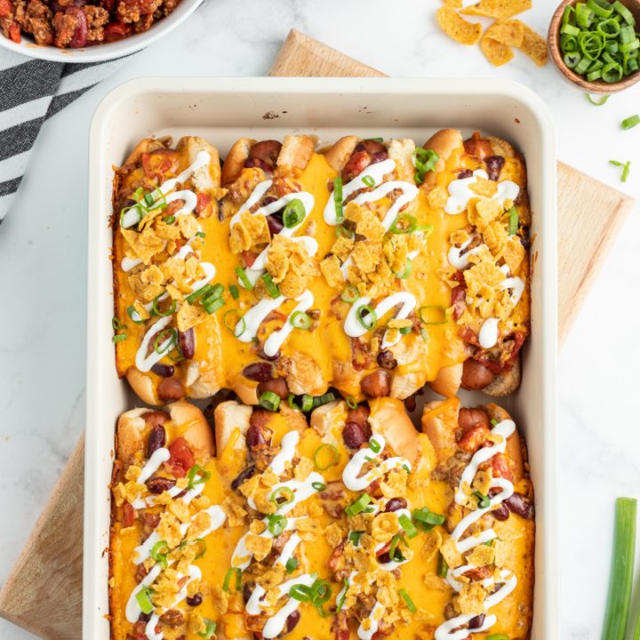 baked chili dogs in white casserole dish