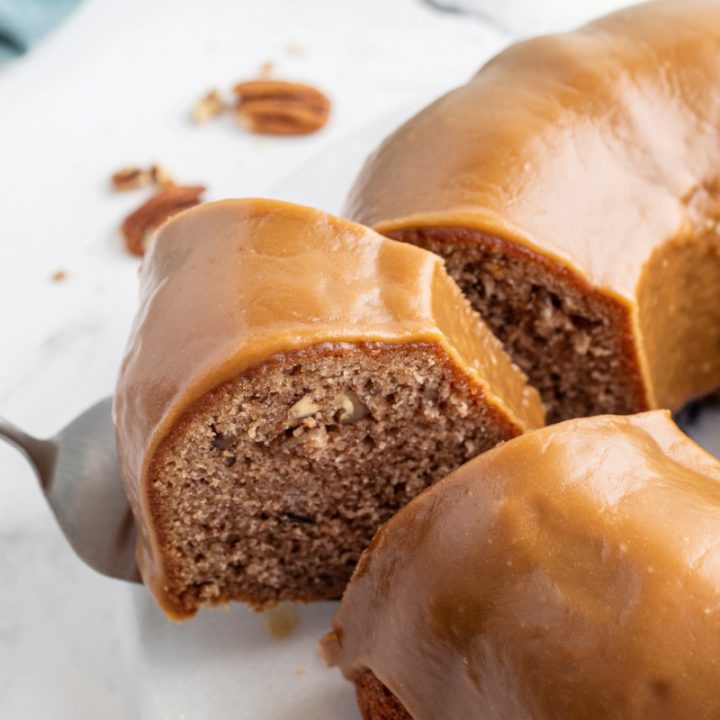 caramel cinnamon roll bundt cake slice coming out of it