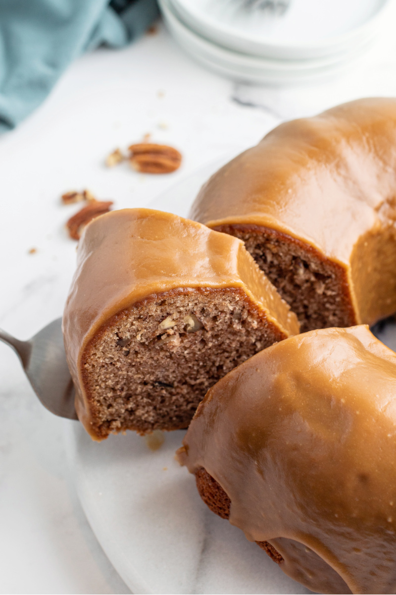 caramel cinnamon roll bundt cake slice coming out of it