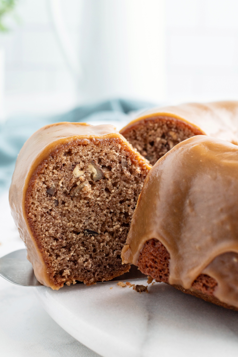 slice coming out of caramel cinnamon roll bundt cake