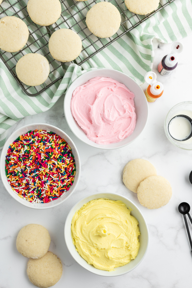 frosting and sprinkles ready to be added to cookies