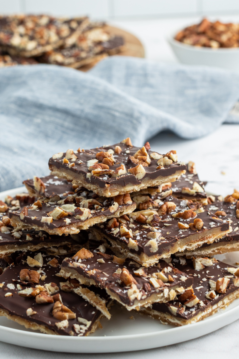 pecan praline chocolate matzoh pieces stacked on white plate