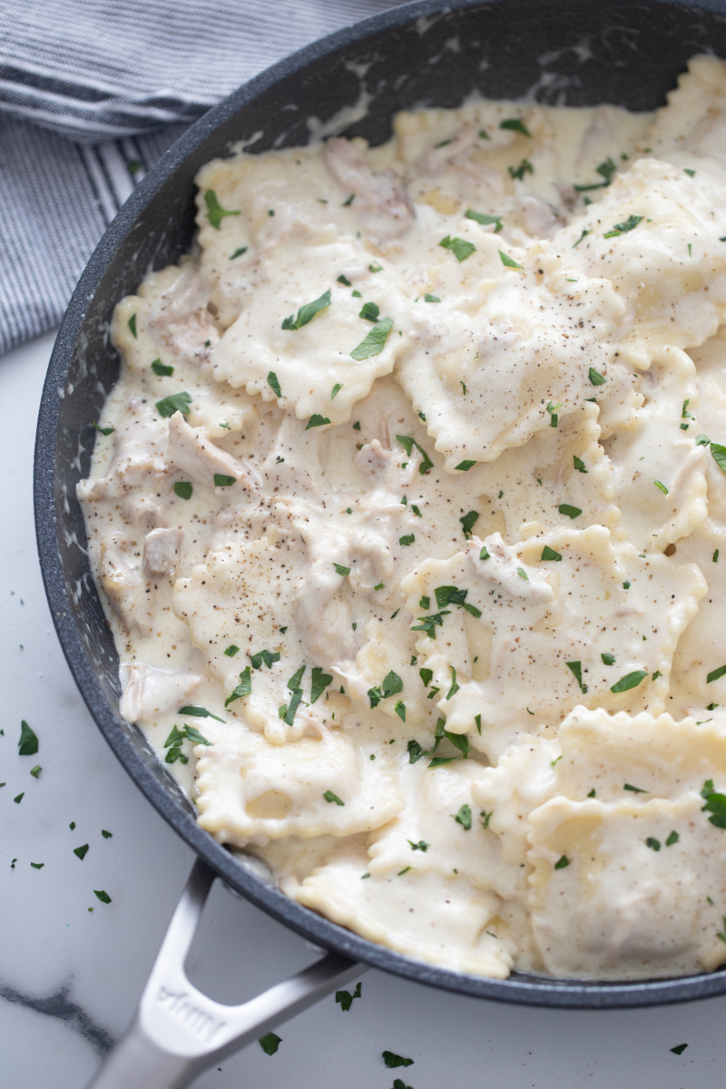 skillet with ravioli and alfredo and chicken