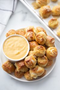 soft pretzel bites served with a bowl of cheese sauce