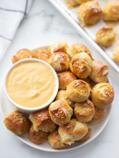 soft pretzel bites served with a bowl of cheese sauce