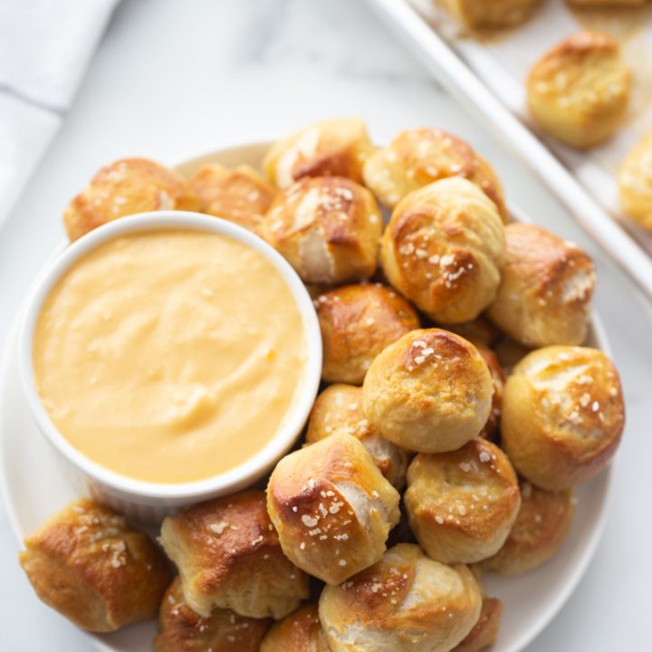 soft pretzel bites served with a bowl of cheese sauce