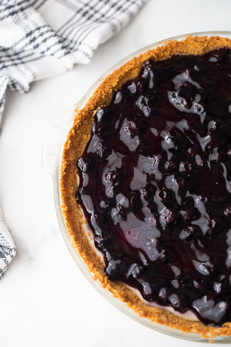 overhead shot of half of blueberry cheesecake pie