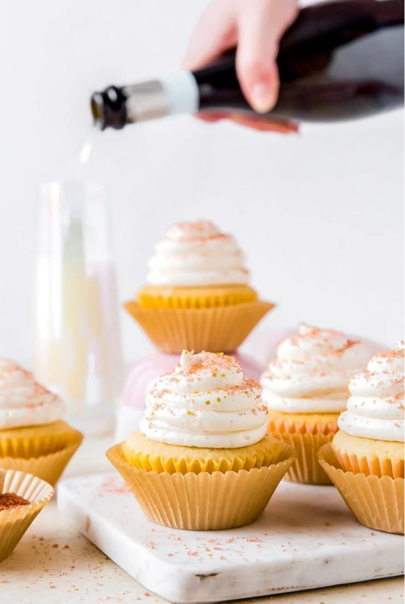 Champagne Cupcakes with champagne pouring in background