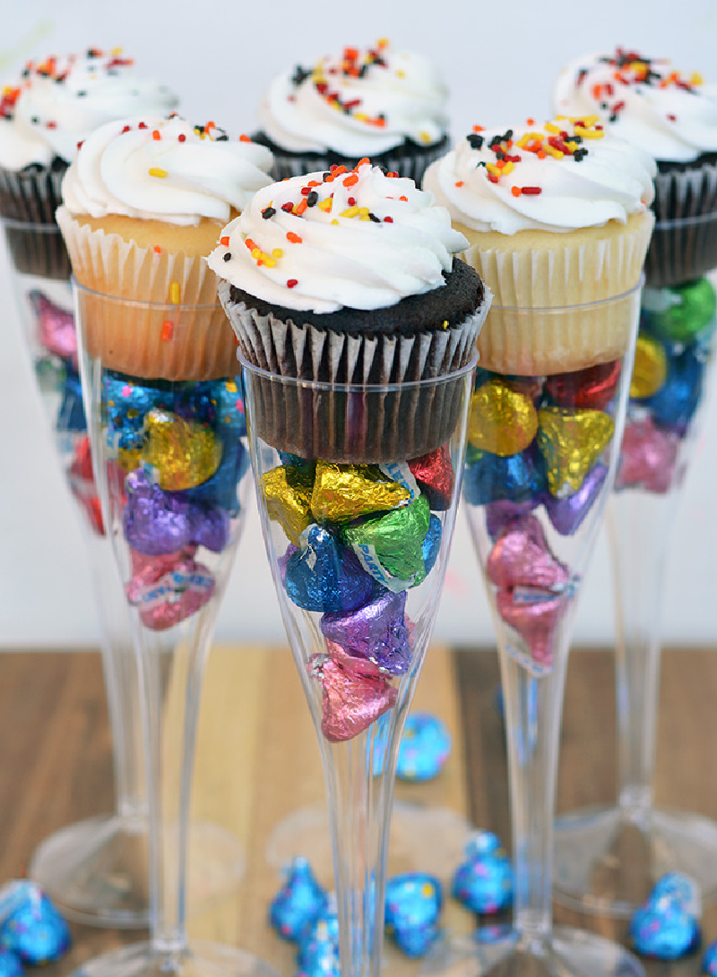 Candy filled flutes with cupcakes on top