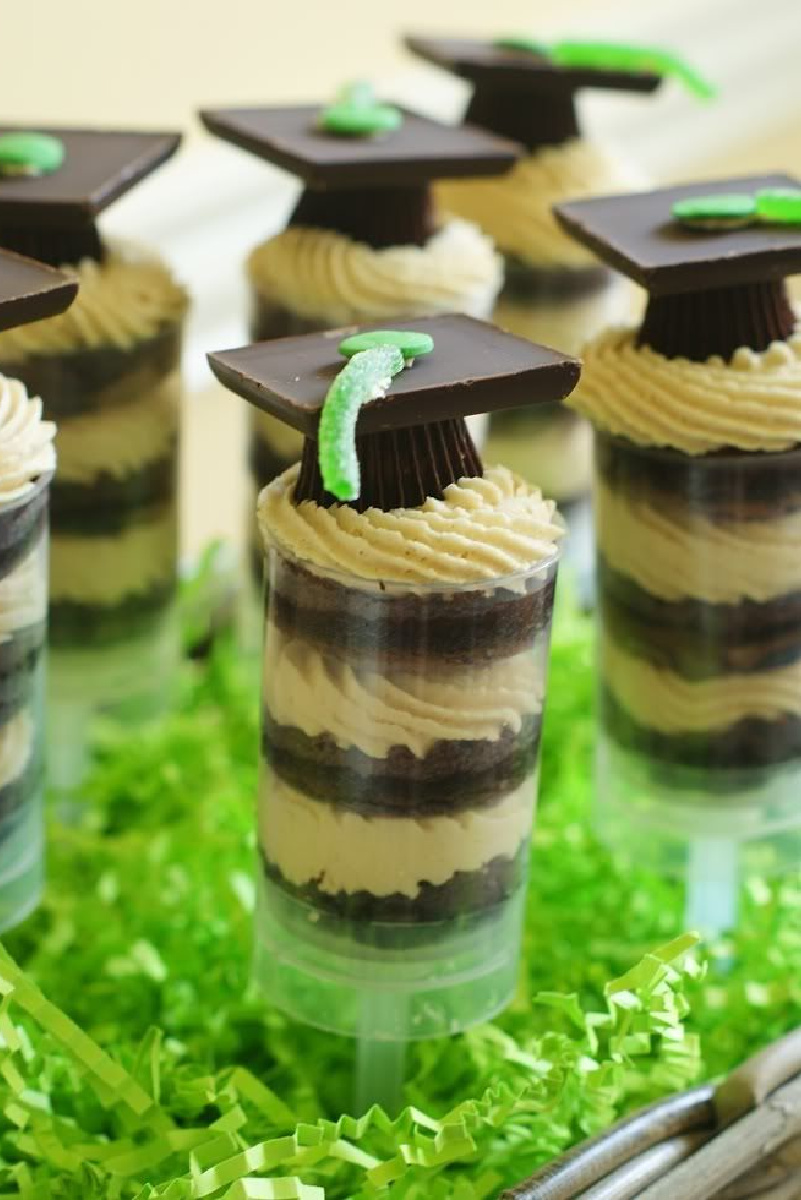 Graduation hats on top of chocolate peanut butter cup push pops