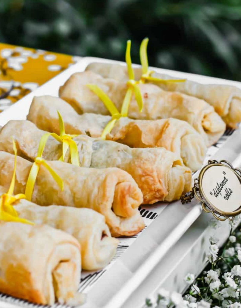 Puff pastry and chocolate diploma rolls on white platter