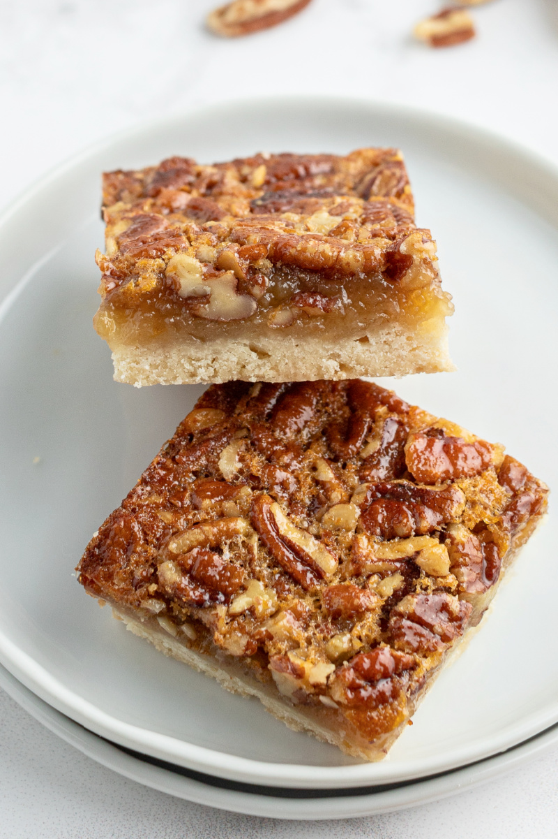 two pecan pie bars on white plate