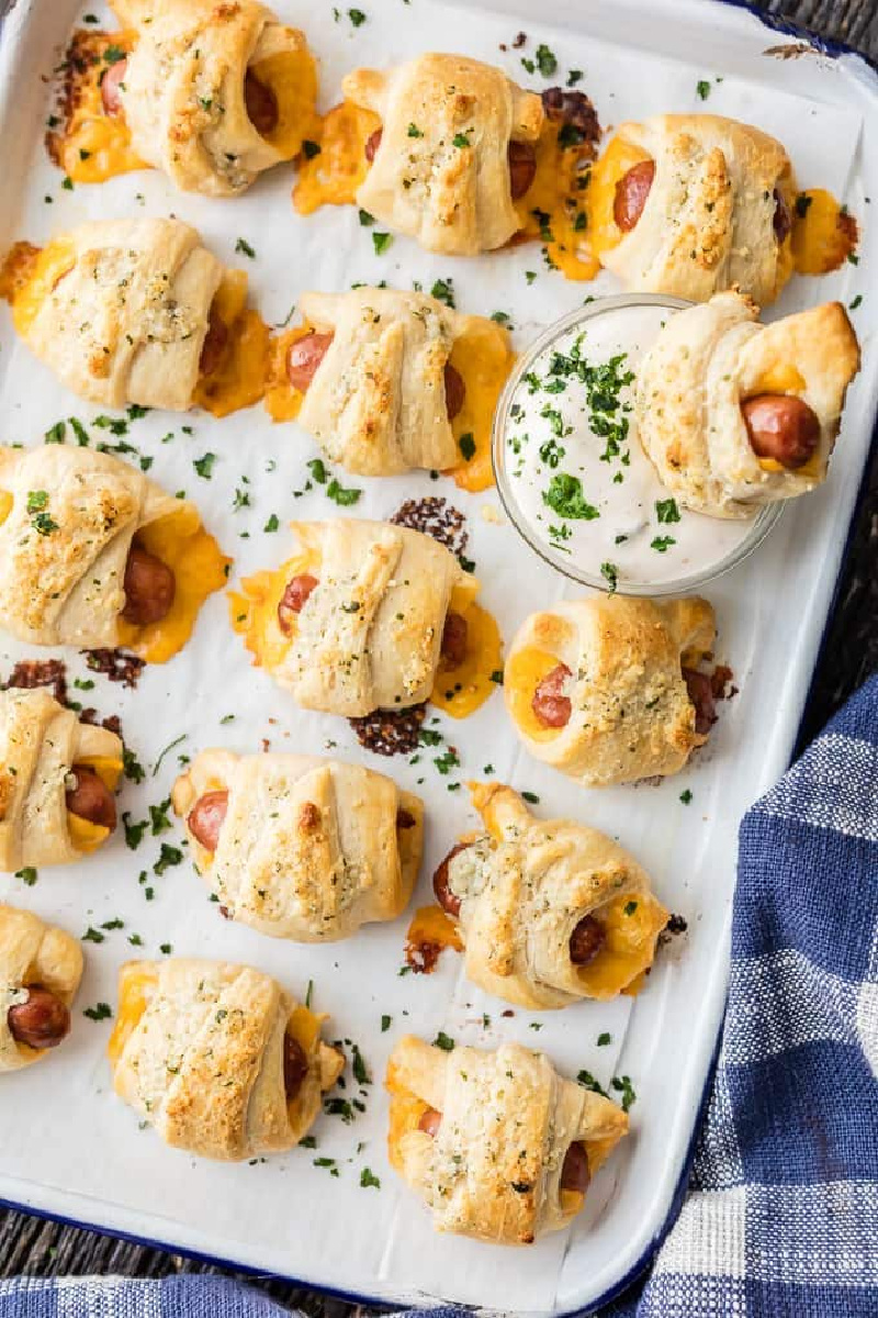 pigs in a blanket with cheese and parmesan ranch butter on white tray