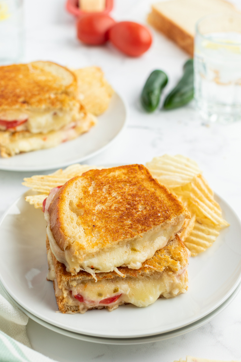 two halves of grilled cheese stacked on white plate