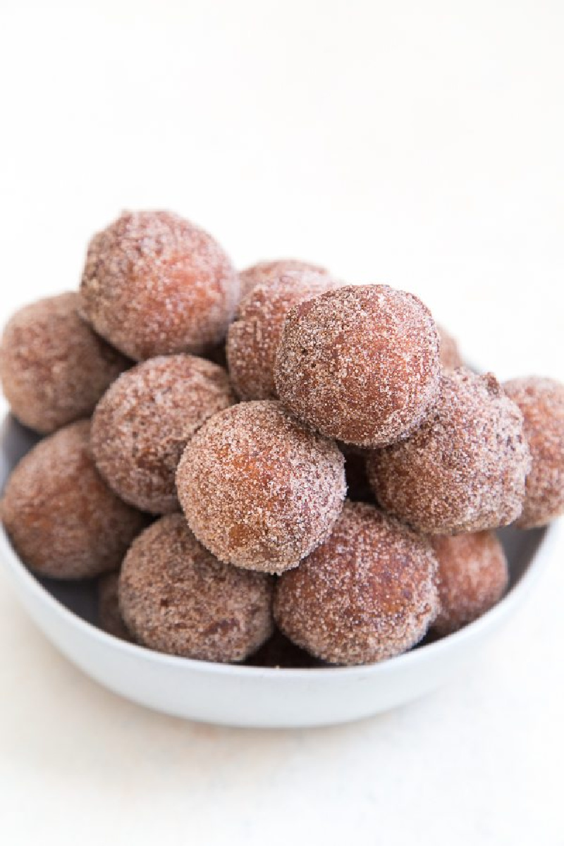 apple cider doughnut holes in a white bowl