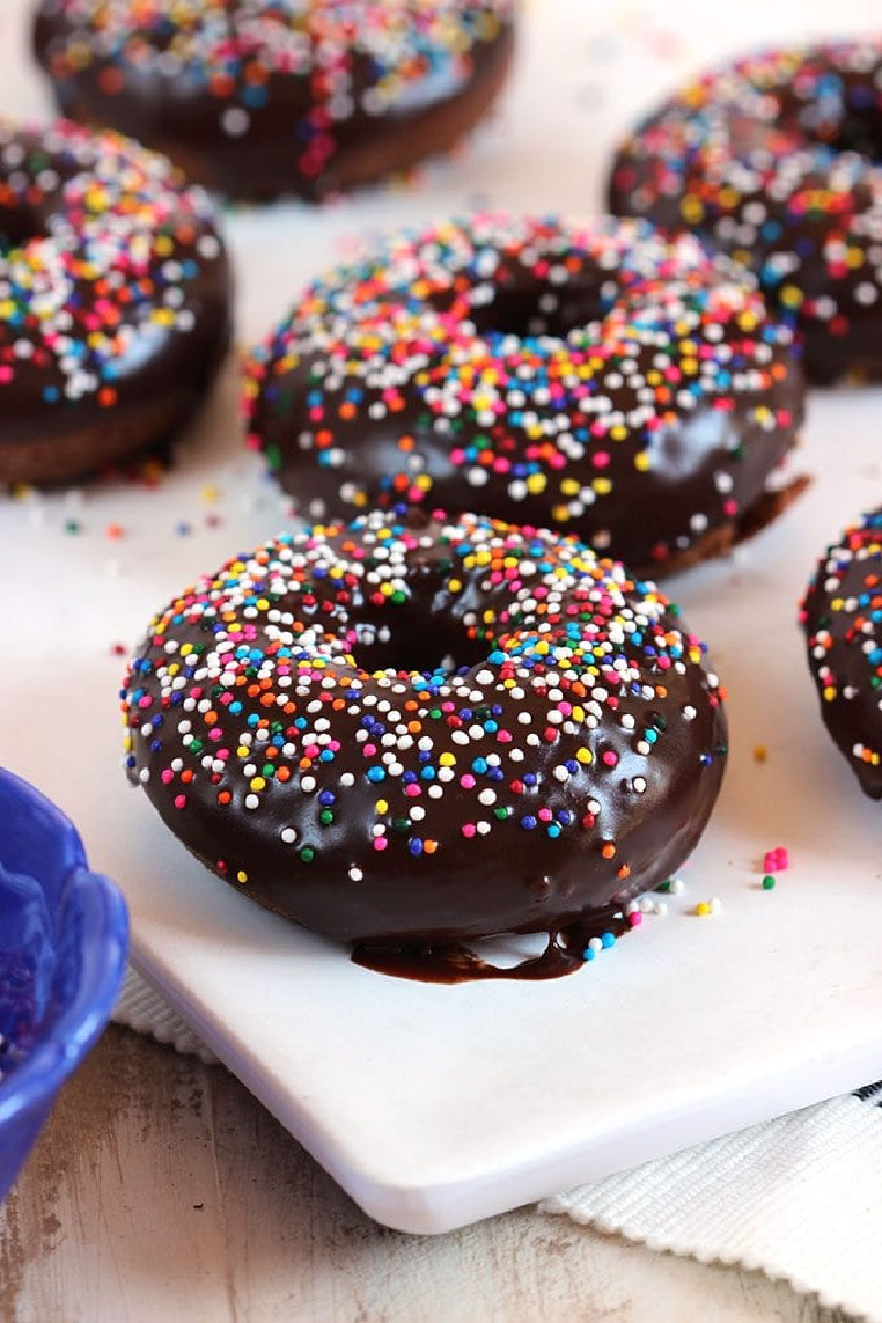 baked chocolate glazed doughnuts on a white plate