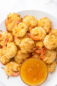 coconut shrimp in a bowl with sauce